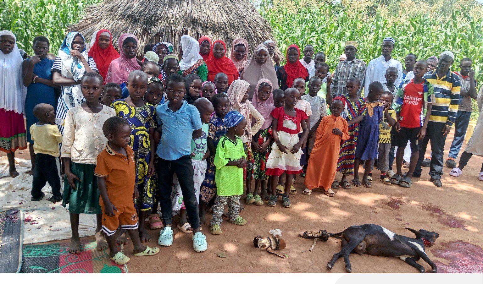 Children and community members gathered in a rural community