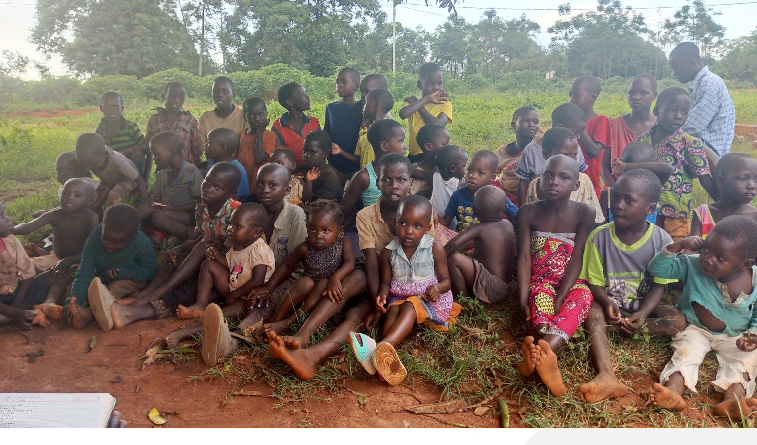 Community members gathered in a village setting